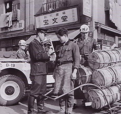 Police officers and MPs confiscating black market goods (Source: The Record of Defeated Japan, Archives Publishing. Original photo owned by the U.S. Department of Defense)